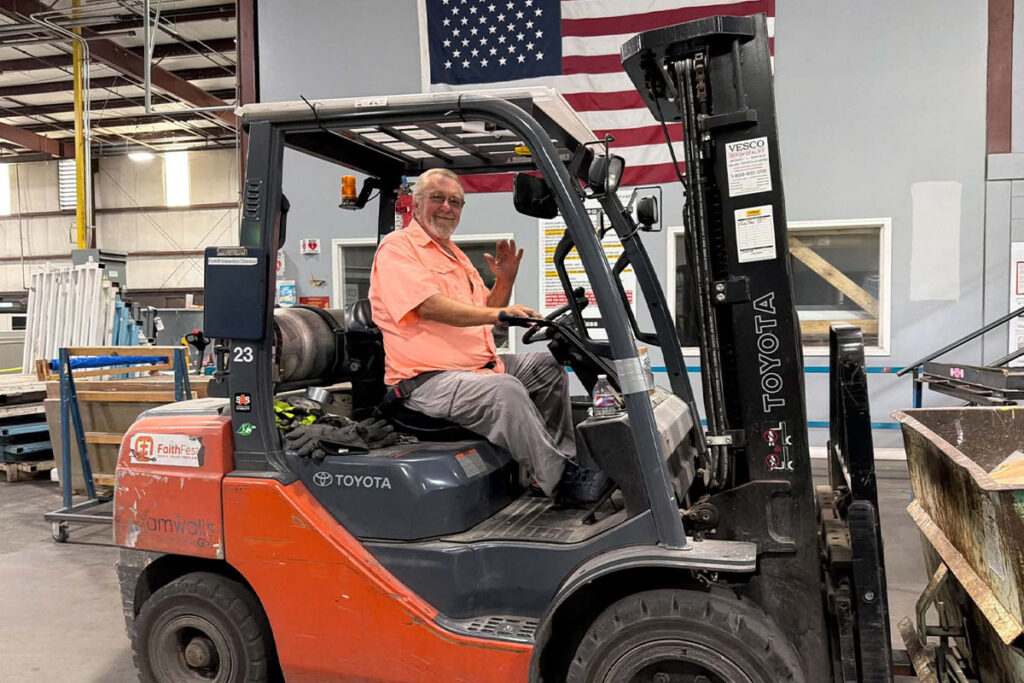 forklift driver moving glass to be recycled at a glass and mirror plant
