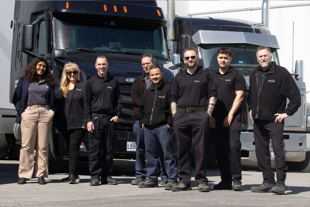 Gw Team Standing In Front Of Delivery Trucks